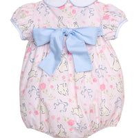 Little English traditional children's clothing. Classic peter pan bubble with capped sleeves and a light blue sash in a light pink bunny print for baby girls. Easter outfit for baby girls.