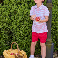 Little English classic children's clothing. Boys red and blue Primary Stripe short sleeve polo paired with red Sport Short. Back to school outfit for boys.