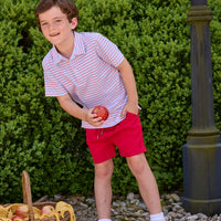 Little English classic children's clothing. Boys red and blue Primary Stripe short sleeve polo paired with red Sport Short. Back to school outfit for boys.