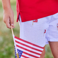 Little English traditional children's clothing. Boy's blue and white seersucker short with embroidered flags for summer. 4th of July shorts for boys