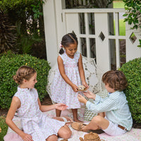 Little English traditional children's clothing. Classic sleeveless button down dress in pink and green floral for older girls