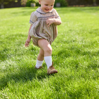 Little English classic children's clothing. Smocked peter pan bubble in tan and blue Durham windowpane with blue piping for baby boys