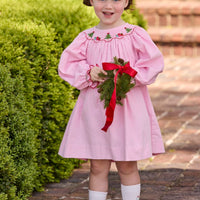 Little English traditional children's clothing. Long sleeve pink corduroy dress with Christmas motif smocking around the neckline for little girls.