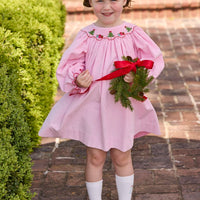 Little English traditional children's clothing. Long sleeve pink corduroy dress with Christmas motif smocking around the neckline for little girls.