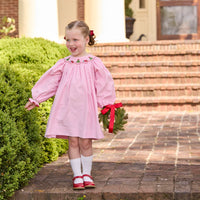 Little English traditional children's clothing. Long sleeve pink corduroy dress with Christmas motif smocking around the neckline for little girls.