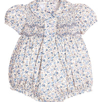 Little English classic children's clothing. Dressy peter pan bubble for baby girls in blue Wisteria Floral with puff sleeves, ruffle details, and smocking at chest. Paired with white cotton knee high socks with navy bow embroidery