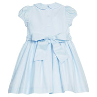 Little English classic smocked emery dress in light blue with white detailing, smocking around chest, tieable in back, for little girl