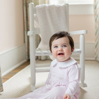 little english baby girl smocked footie with pink geo design and white peter pan collar