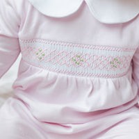 little english baby girl smocked footie with pink geo design and white peter pan collar