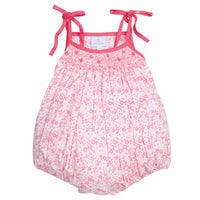 Little English traditional children's clothing. Hot pink and light pink floral bubble with self-tie shoulder straps and smocking at the top for baby girls