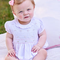 Little English traditional children's clothing. Dressy white bubble with floral smocking for baby girls for Spring. Special occasion outfit for baby girl