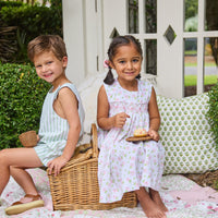 Little English traditional children's clothing. White sleeveless smocked dress with pink and green florals for little girls