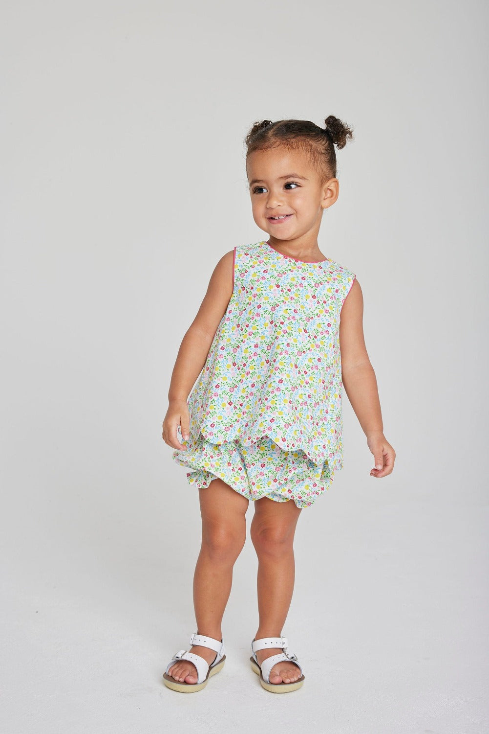 Little English girl's floral bloomer set with scallop details and bow in back