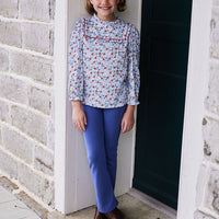 classic childrens clothing girls blouse in blue and red floral pattern with ruffles around neck and sleeves and red piping detailing