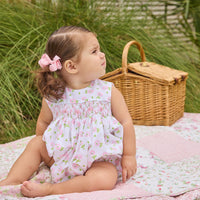 Little English traditional children's clothing.  White sleeveless smocked bubble with pink and green florals for baby girls