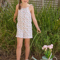 Little English traditional children's clothing.  White romper with red and pink tulip print and self-tie straps for little girls