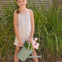 Little English traditional children's clothing.  White romper with red and pink tulip print and self-tie straps for little girls
