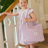 Little English traditional children's clothing. Classic dress for toddler girls in lavender stripe seersucker with peter pan collar and ballet slipper embroidery