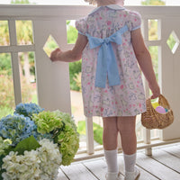 Little English traditional children's clothing.  Classic peter pan dress with capped sleeves and a light blue sash in a light pink bunny print for little girls.  Easter outfit for girls.