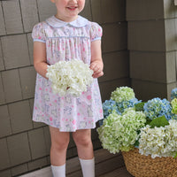 Little English traditional children's clothing.  Classic peter pan dress with capped sleeves and a light blue sash in a light pink bunny print for little girls.  Easter outfit for girls.