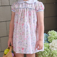 Little English traditional children's clothing.  Classic peter pan dress with capped sleeves and a light blue sash in a light pink bunny print for little girls.  Easter outfit for girls.