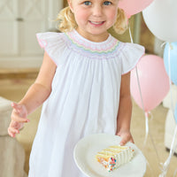 Little English traditional children's clothing. White flutter sleeve dress for toddler girls with rainbow smocking at the collar.  Birthday dress for little girls