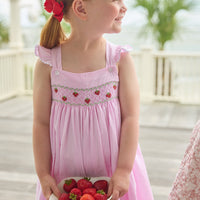 Little English traditional children's clothing.  Light pink seersucker gingham dress for little girls with flutter sleeves and strawberry smocking across the chest