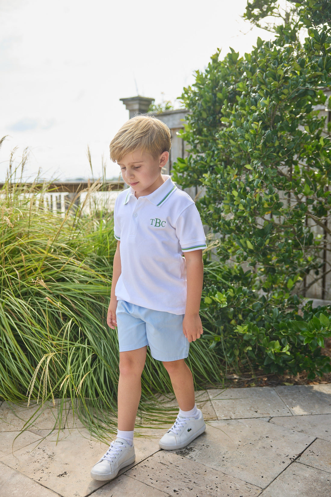 White short sleeve polo with blue and green tipping for boys, light blue elastic waist short 