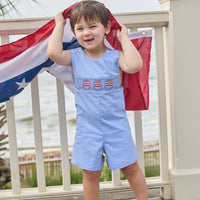 Little English traditional children's clothing.  Classic john john for toddler boys in royal blue mini gingham with American flag smocking at the chest