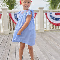 Little English traditional children's clothing. Flutter sleeve dress for toddler girls in royal blue mini gingham with smocking at the collar and American flag bunting