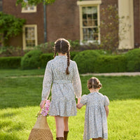 Little English traditional children's clothing. Capped sleeve blue, brown, and cream floral smocked dress with peter pan collar for little girls.