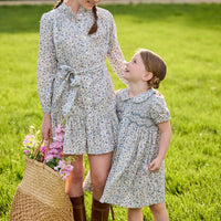 Little English traditional children's clothing. Capped sleeve blue, brown, and cream floral smocked dress with peter pan collar for little girls.