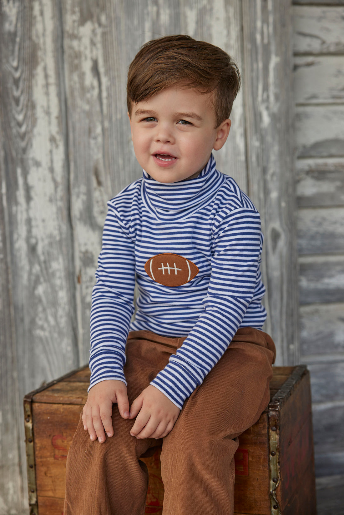Little English toddler boy classic children’s apparel blue and white stripe knit turtleneck with football applique on chest 