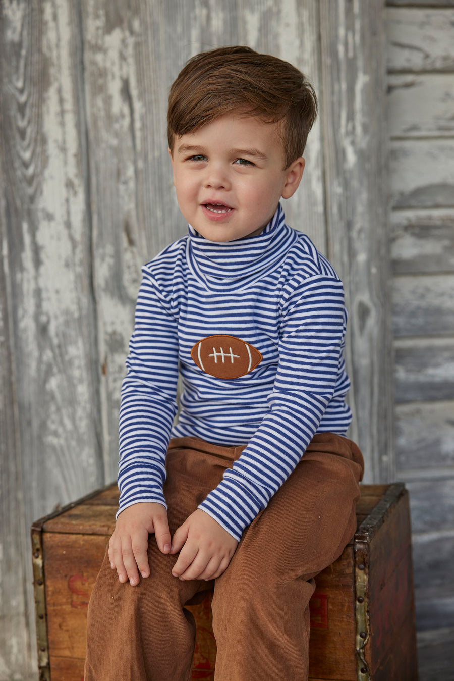 Little English toddler boy classic children’s apparel blue and white stripe knit turtleneck with football applique on chest 