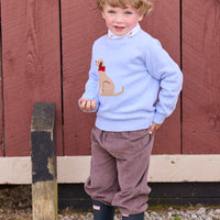 Little English traditional children's clothing. Light blue crew neck intarsia sweater with seated lab motif layered over lab printed turtleneck and paired with chocolate brown corduroy banded pants.