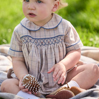 Little English classic children's clothing.  Smocked peter pan bubble in tan and blue Durham windowpane with blue piping for baby boys