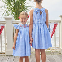 Little English traditional children's clothing.  Royal blue mini gingham sleeveless dress with white ricrac trim and bow tie in back for little girls