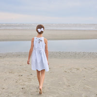 Little English traditional children's clothing.  Light blue and white Savannah Stripe sleeveless dress with white bow tie in back for little girls