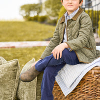 Little English classic childrens clothing, unisex button snap quilted jacket in olive green with corduroy details, Quarter zip sweater in light gray, button down shirt in blue and green coventry plaid, Classic pant in navy corduroy 