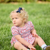 Little English traditional children's clothing.  Soft blue and raspberry red Lennox Floral short sleeve bubble for baby girls with ruffle collar and blue piping detail at sleeves and chest