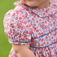 Little English traditional children's clothing.  Soft blue and raspberry red Lennox Floral short sleeve bubble for baby girls with ruffle collar and blue piping detail at sleeves and chest