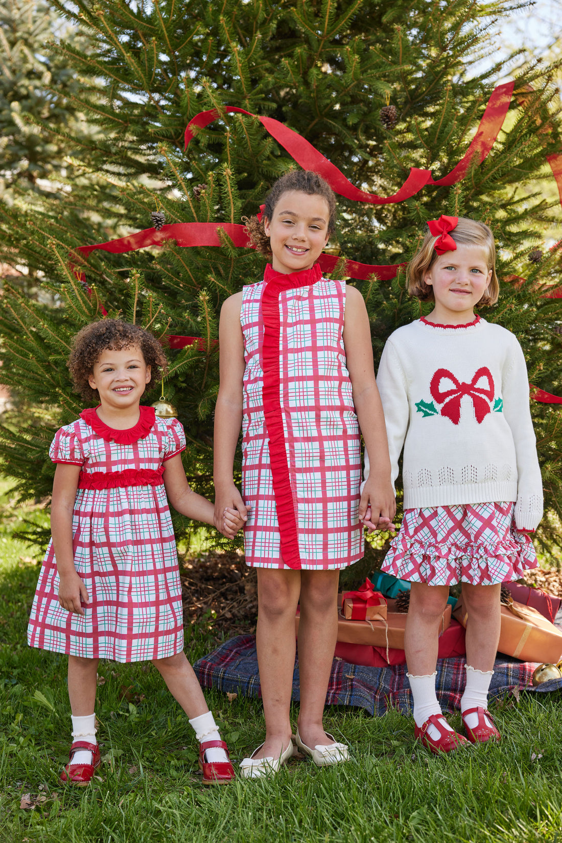 Little English classic tween girl dress in holiday plaid pattern with red ruffle running around neck and down front