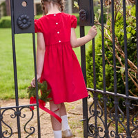 Little English traditional children's clothing.  Red corduroy dress with capped sleeves and off-center fixed bow at waist.  Holiday dress for little girls.