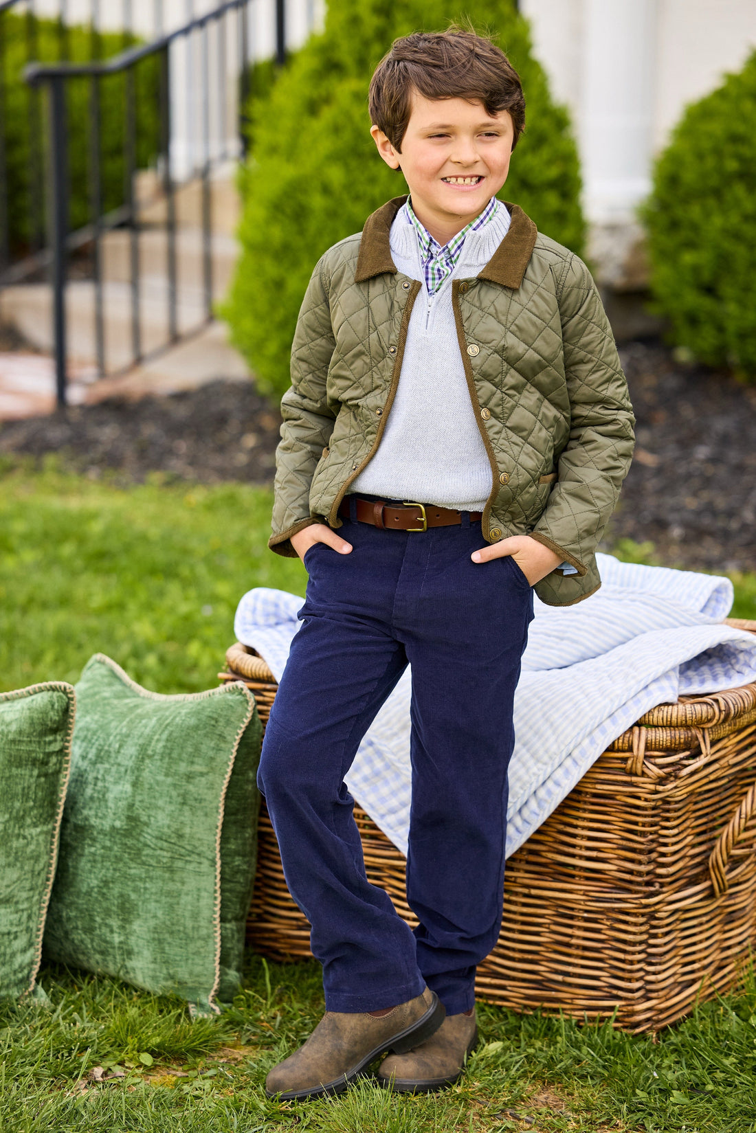 Little English classic childrens clothing, unisex button snap quilted jacket in olive green with corduroy details, Quarter zip sweater in light gray, button down shirt in blue and green coventry plaid, Classic pant in navy corduroy 