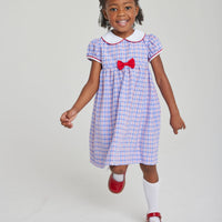 Little English toddler girl traditional red white and blue gingham woven dress with red and white piping