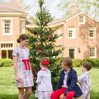 Little English classic children's clothing. Girls A-line Cora Dress in red and green plaid with red bow and red piping detail for the holidays.  Boys Douglas Plaid button down shirt with red corduroy pants and navy wool blazer. Toddler girls Eleanor Dress - Douglas Plaid with ruffled peter pan collar and tie sash in back paired with white Holiday Bow Fair Isle Cardigan.  Toddler boys Douglas Plaid Button Tab John John Set
