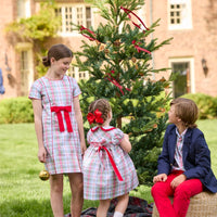 Little English classic children's clothing. Girls A-line Cora Dress in red and green plaid with red bow and red piping detail for the holidays.  Boys Douglas Plaid button down shirt with red corduroy pants and navy wool blazer. Toddler girls Eleanor Dress - Douglas Plaid with ruffled peter pan collar and tie sash in back.