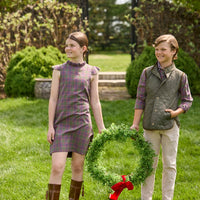 Little English traditional children's clothing. Olive and maroon Thornhill Plaid column dress with capped sleeves, ruffled neckline, and fixed bow in back for older girls for the holidays.  Boys Button Down Shirt in Thornhill Plaid with Classic Quilted Vest in Olive layered over top. Paired with Classic Pant in tan Stone Corduroy.