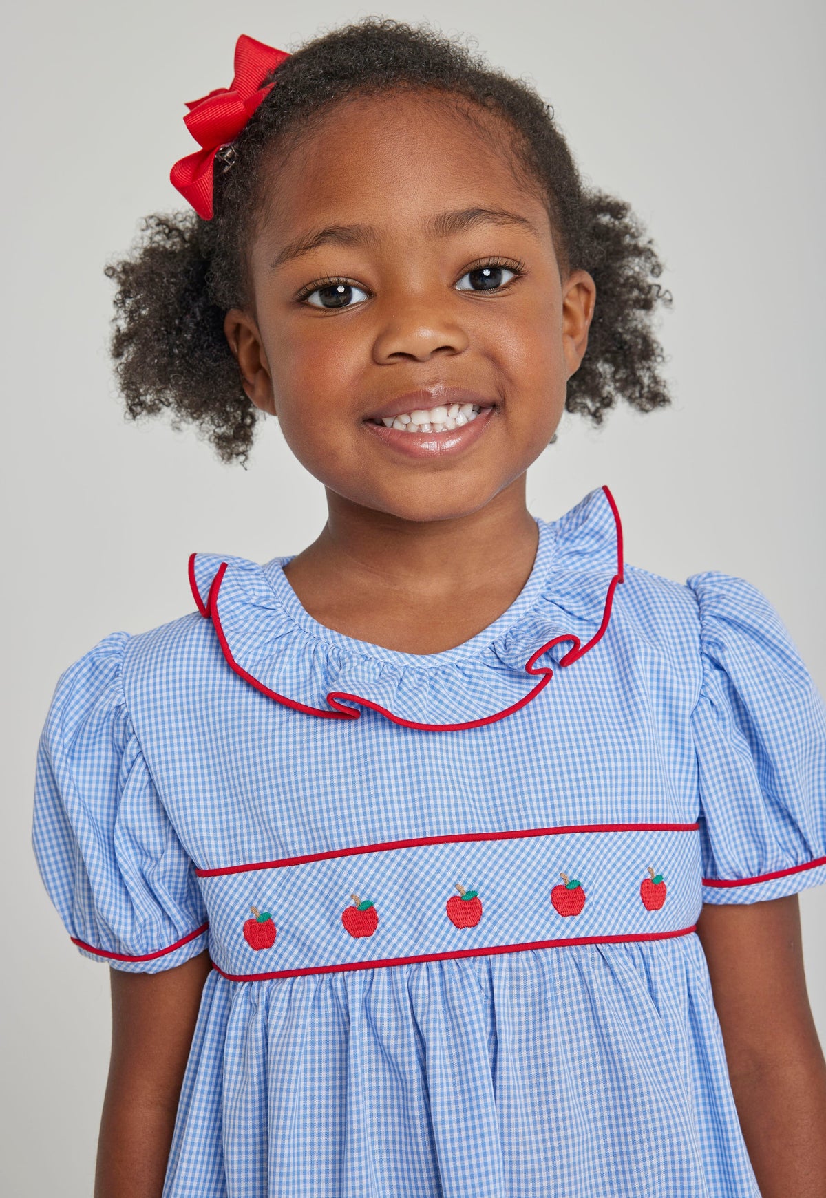 Little English toddler girl traditional blue woven dress with apple embroidery