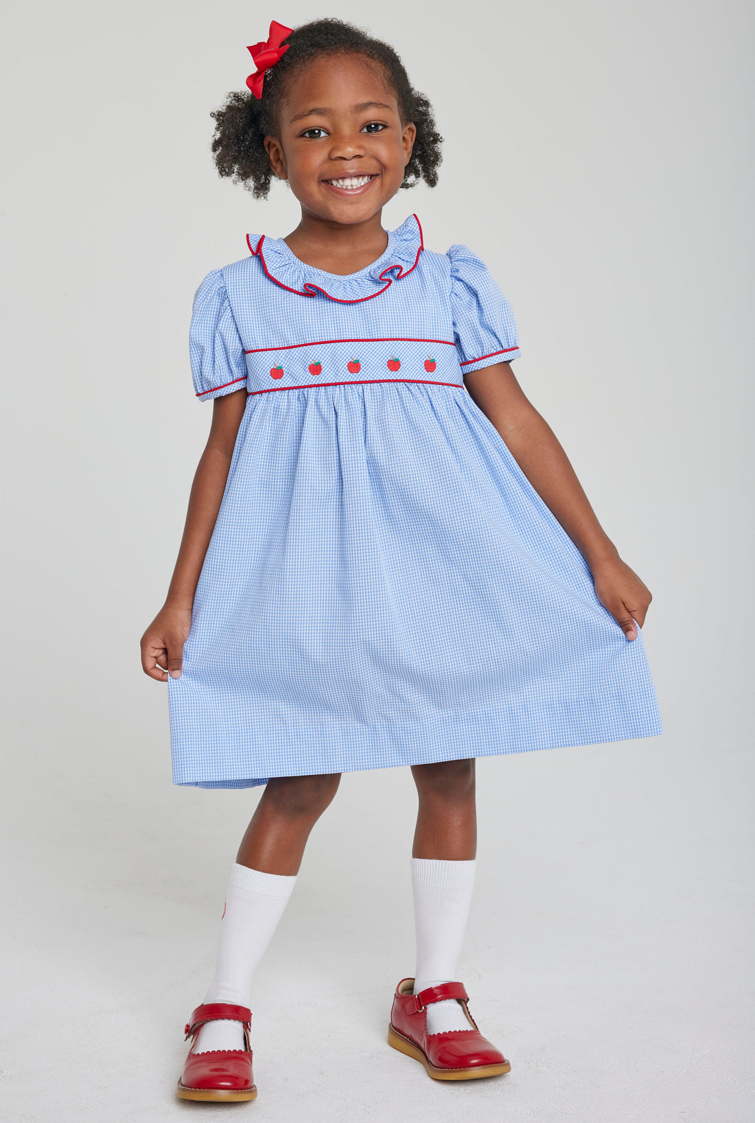 Little English toddler girl traditional blue woven dress with apple embroidery